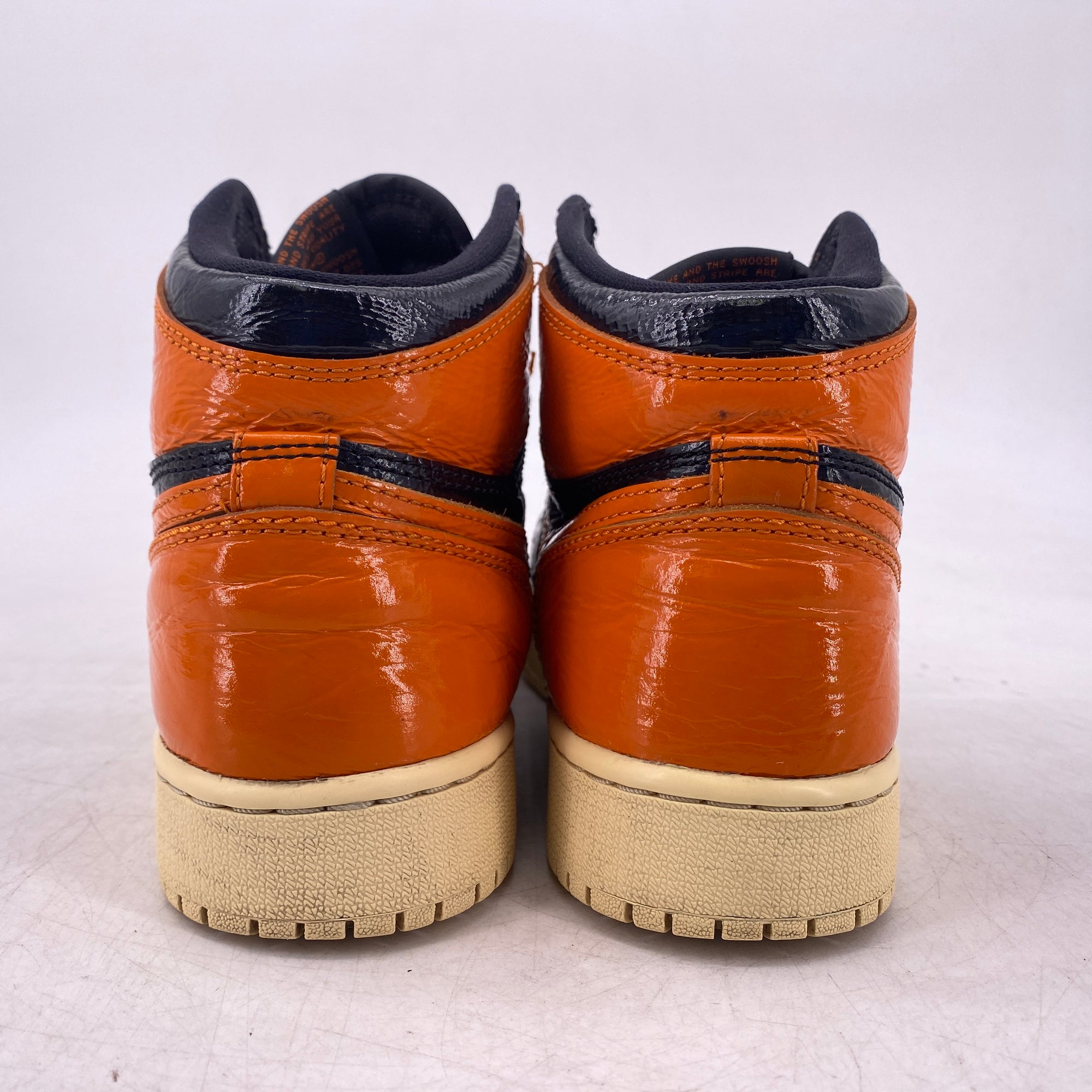 high top nike sneakers with swirls on back pain